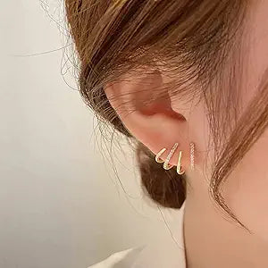 Delicate curved bar ear studs in gold finish