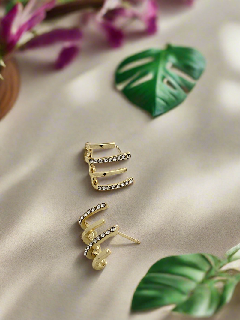 Delicate curved bar ear studs in gold finish